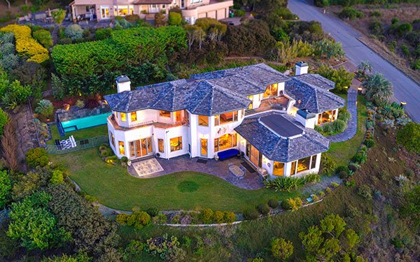 large house with pool behind